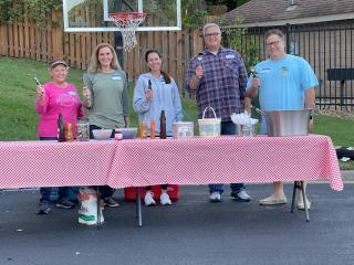 Homeowners ready to scoop ice cream at neighborhood social.