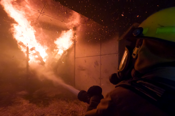 Image of firefighter putting out fire.