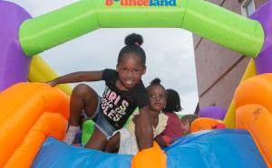 Children play in bounce house at National Night Out in Garfield