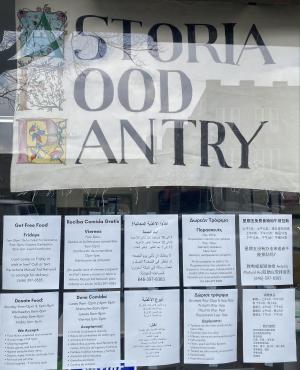The food pantry window with signs in English, Spanish, Arabic, Greek, and Chinese
