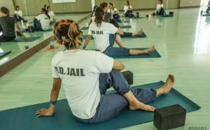 Women in prison in a yoga class