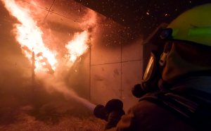 Image of firefighter putting out fire.