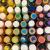 An aerial view of colorful paint caps arranged in rainbow order